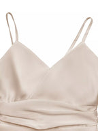 Beige satin dress with thin straps on a white background