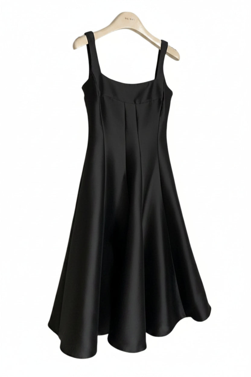 Black sleeveless dress on a hanger against a white background