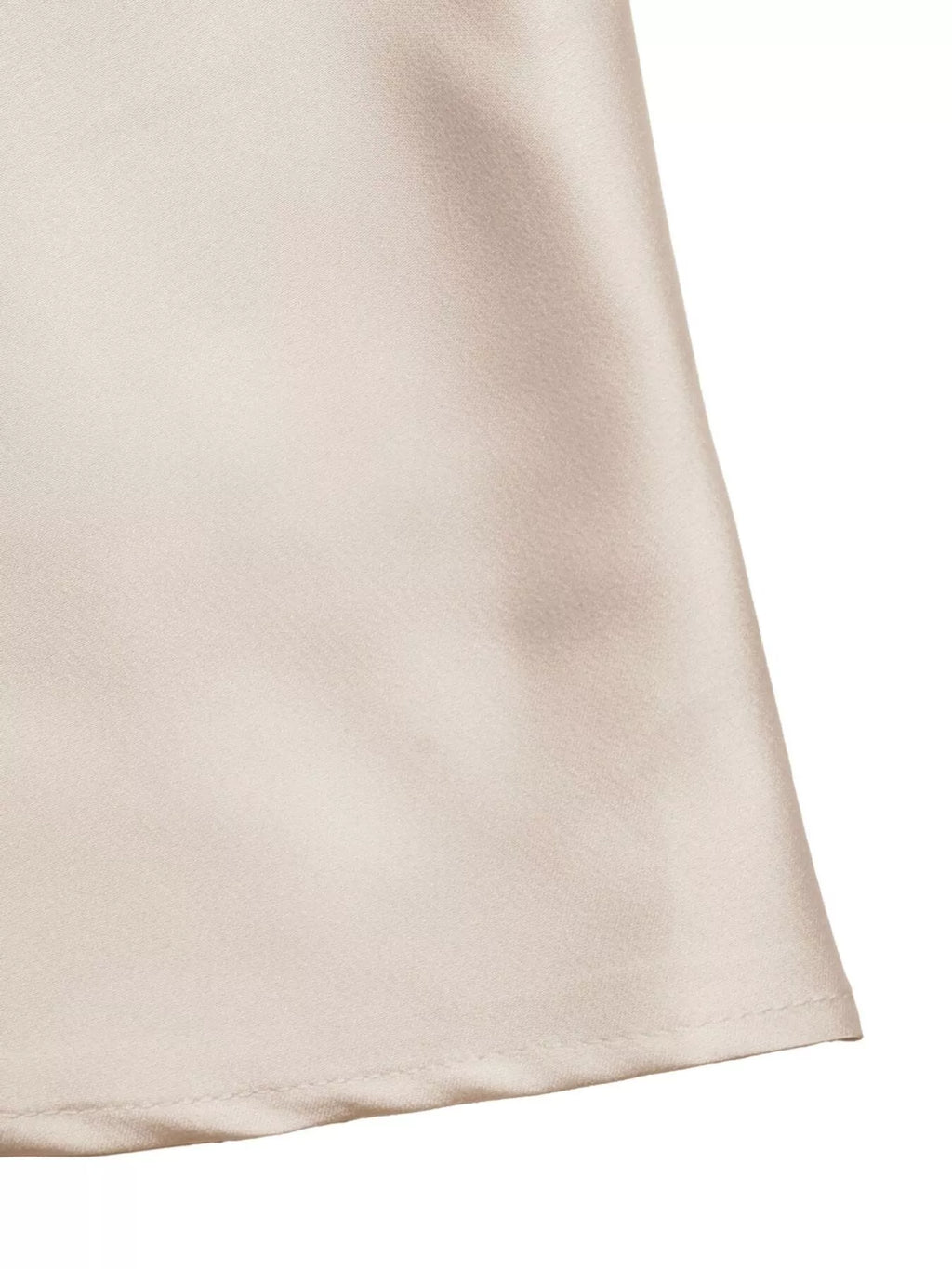 Close-up of a beige fabric corner on a white background
