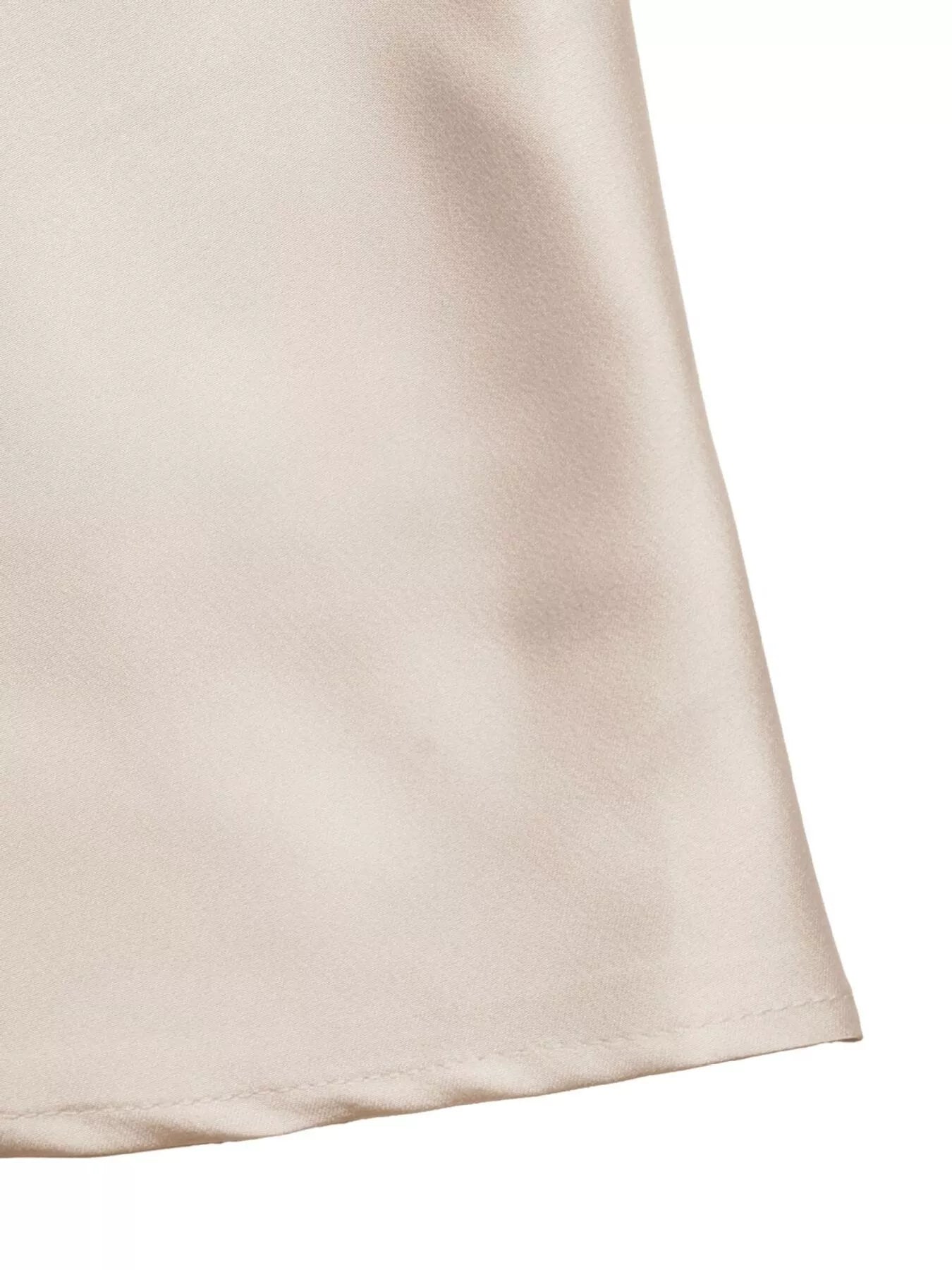 Close-up of a beige fabric corner on a white background