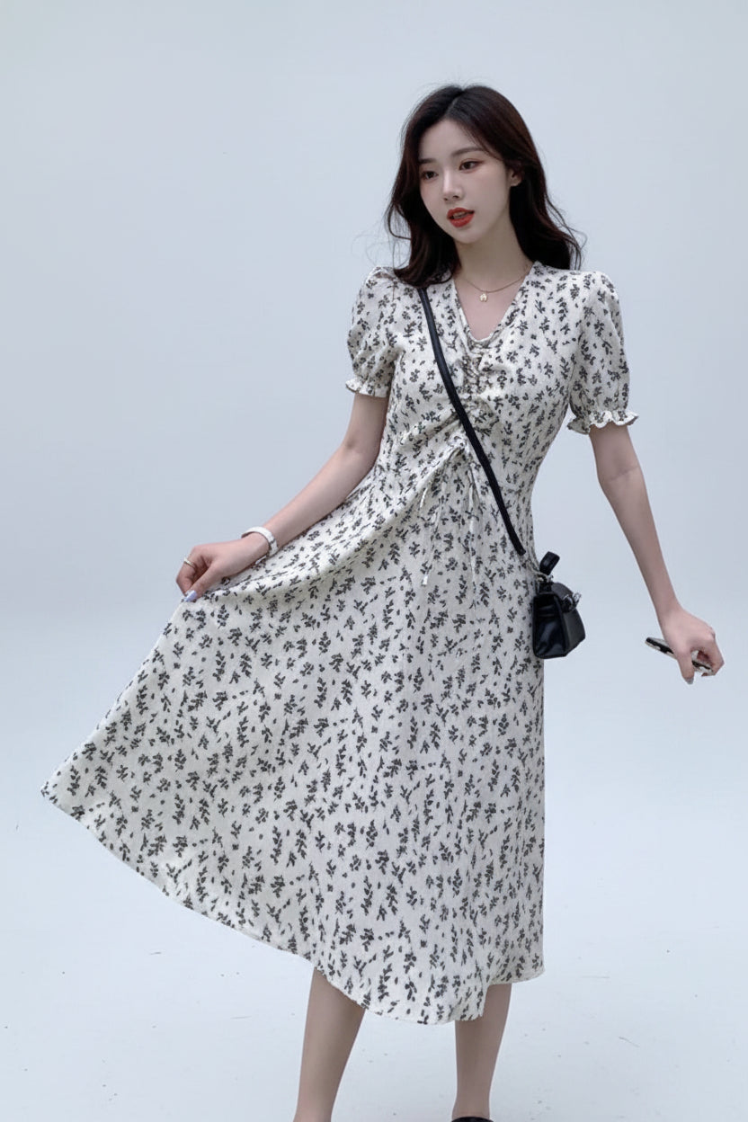 Woman wearing a floral dress against a plain background