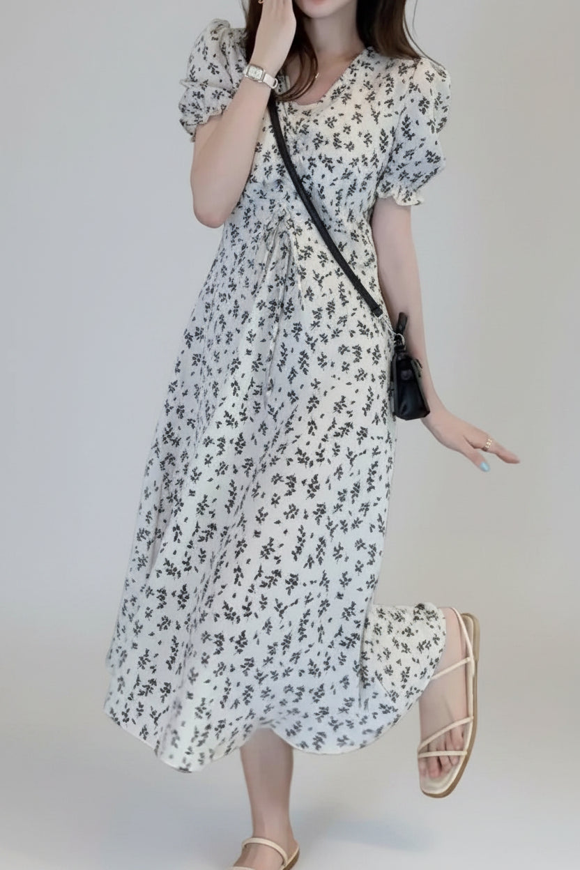 Woman wearing a floral dress in an indoor setting
